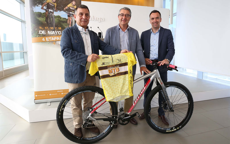 Organizadores de la Vuelta a Andalucía posan junto a una bici